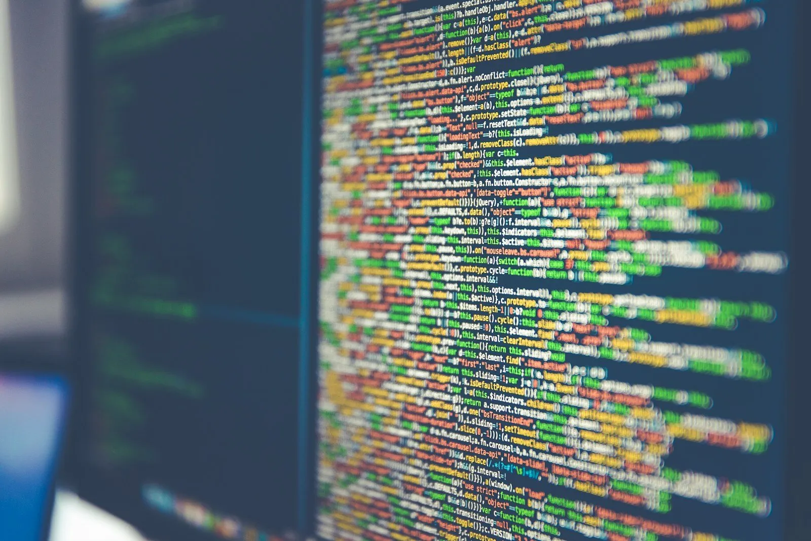 Bunter Code auf einem Computer-Monitor, Symbolbild für KI-generierten Code
